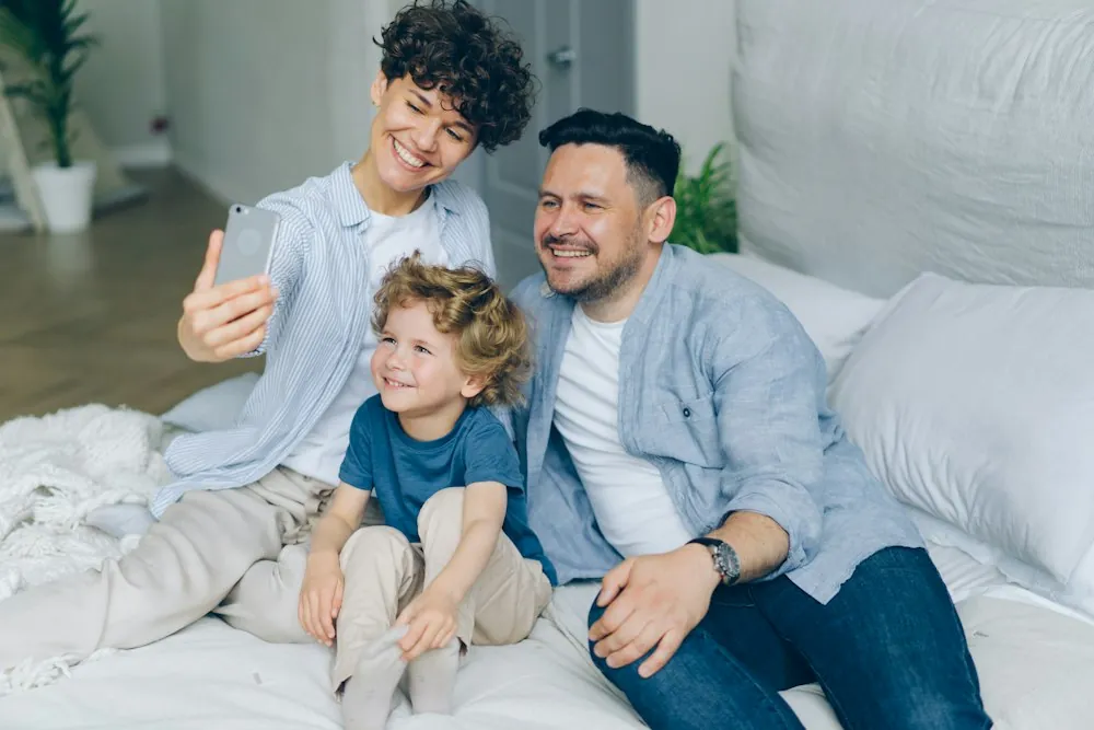Family relaxing together on a comfortable bed — the people we write for